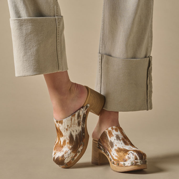A woman wearing the Talisa heeled clog in Multi Color Hair Calf (Multicolor).