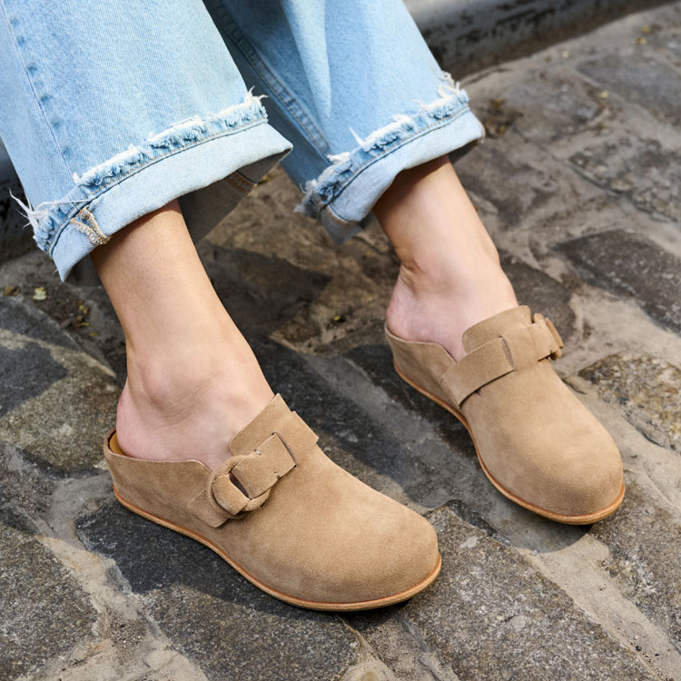 A woman wearing the Kori clog in taupe (tan). Shop Kori.