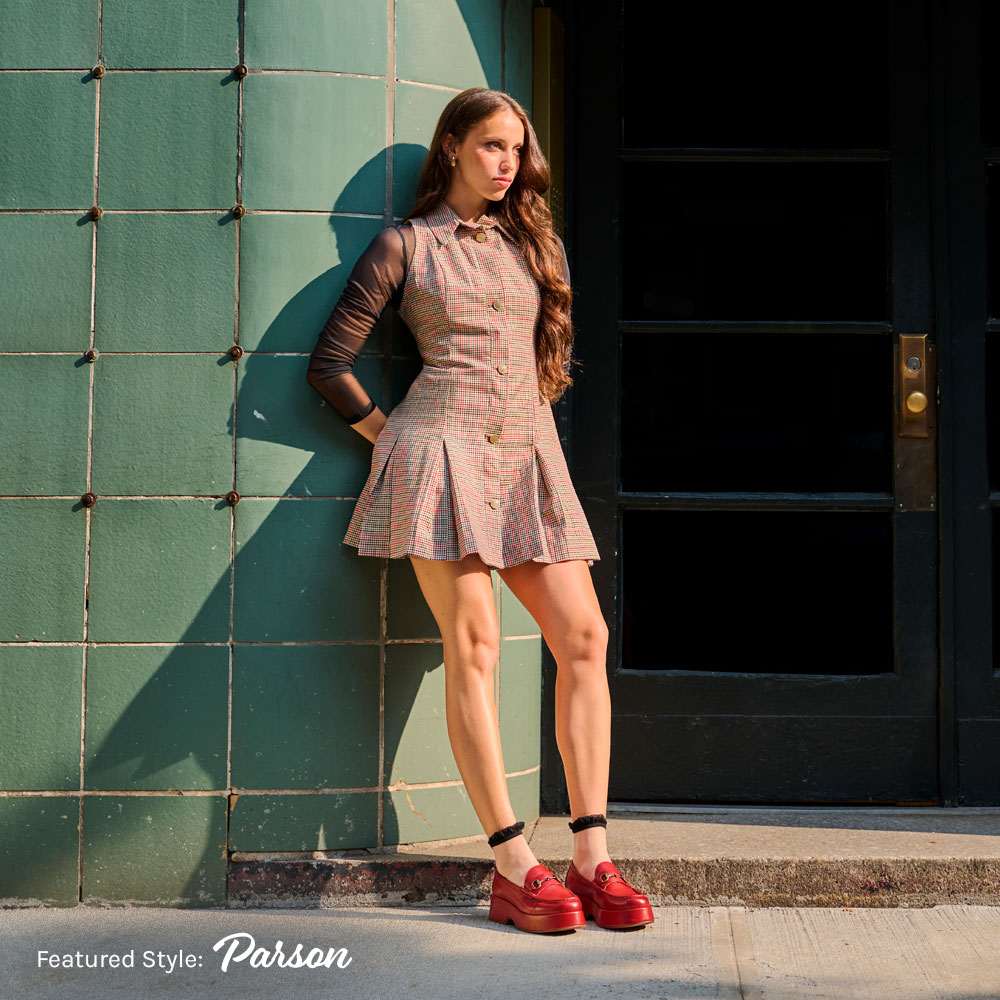 A woman wearing the Parson platform loafer in dark red.